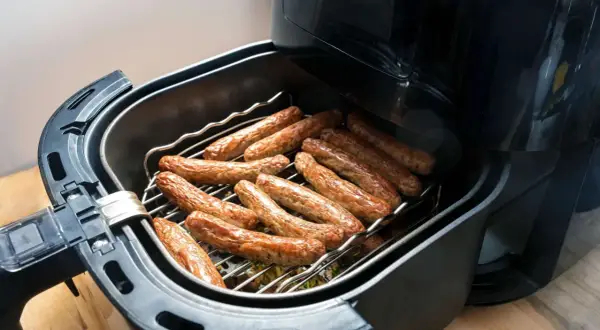 Luftfritteuse mit vielen Bratwürsten, perfekt für schnelle Bratwurst Rezepte.