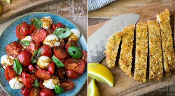 Tomate Mozzarella Salat mit frischem Basilikum und paniertes Schnitzel, dazu Zitronenspalten.